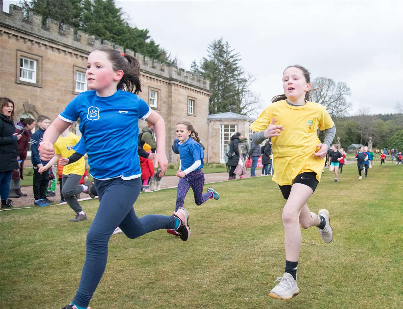 EL_PR Cross Country 2024 21(Bishopmill Primary - left) and Ellie Chalmers from Linkwood Primary School race to the finish line in the Primary 4/5 Girls race.Active Schools Primary Cross Country 2024, held at Gordon Castle, Fochabers. Picture: Daniel Forsyth.