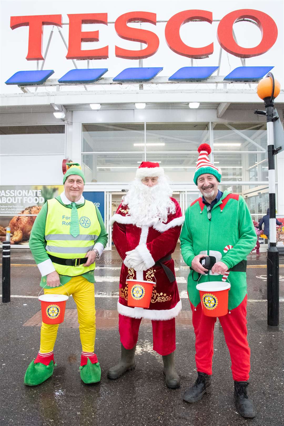 Santa is joined by head Elf Donnie (left) and Forres' Tesco Community Champion Michael Walker (right).