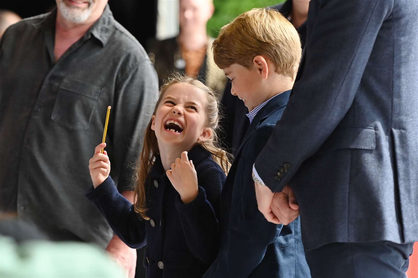 Charlotte laughs as she conducts a band next to her brother, Prince George (Ashley Crowden/PA)