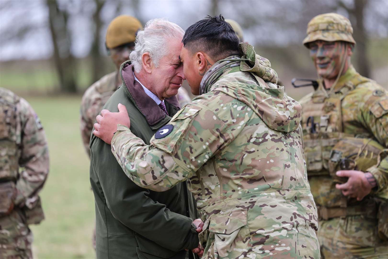 The King receives the hongi from a New Zealander in the Ukrainian contingent during a visit to a training site for Ukrainian military recruits (Chris Jackson/PA)