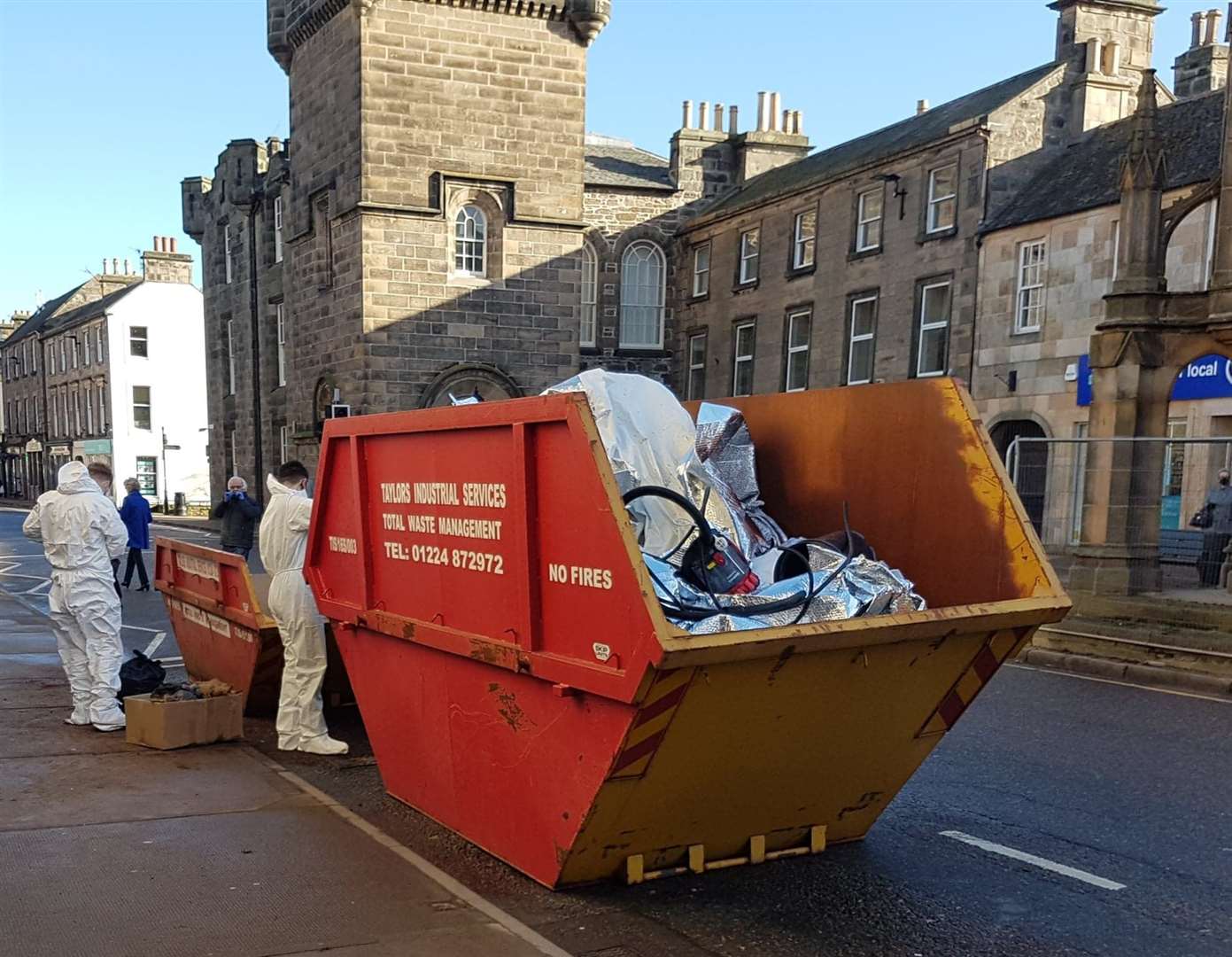 The skip being filled on Forres High Street.