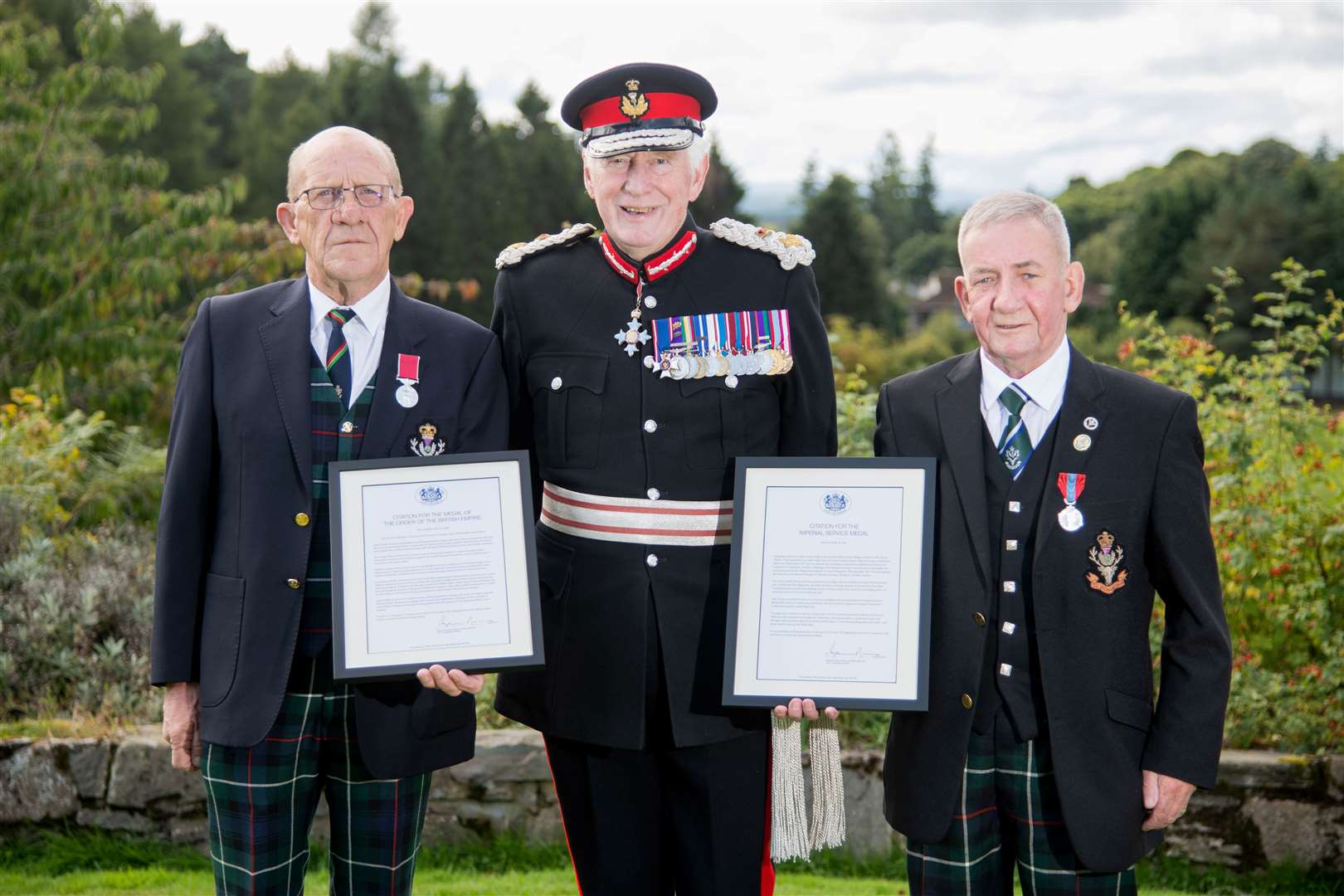 Forres' Albert Duffus (left) is presented with his BEM by Lord Lieutenant of Moray Seymour Monro at Forres Golf Club while Ian 'Chalky' Whyte (right) is presented with the Imperial Service Medal...Picture: Daniel Forsyth..