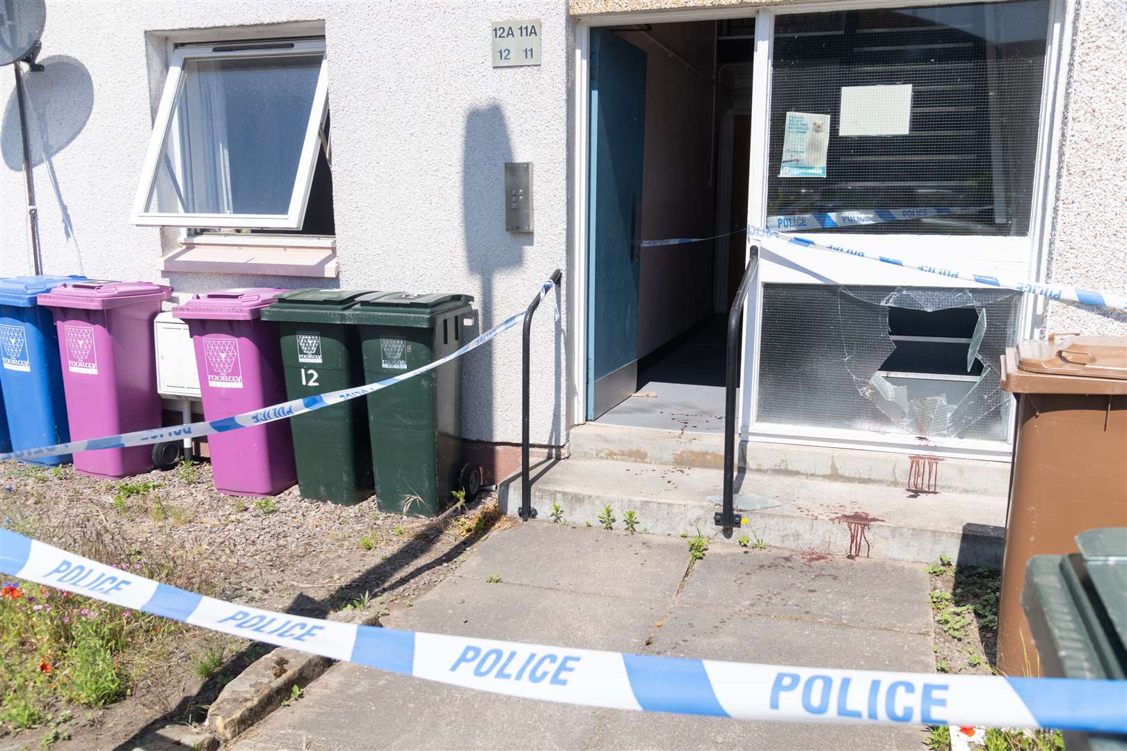 A smashed window and blood-stained floor at the property on North Road. Picture: Beth Taylor.