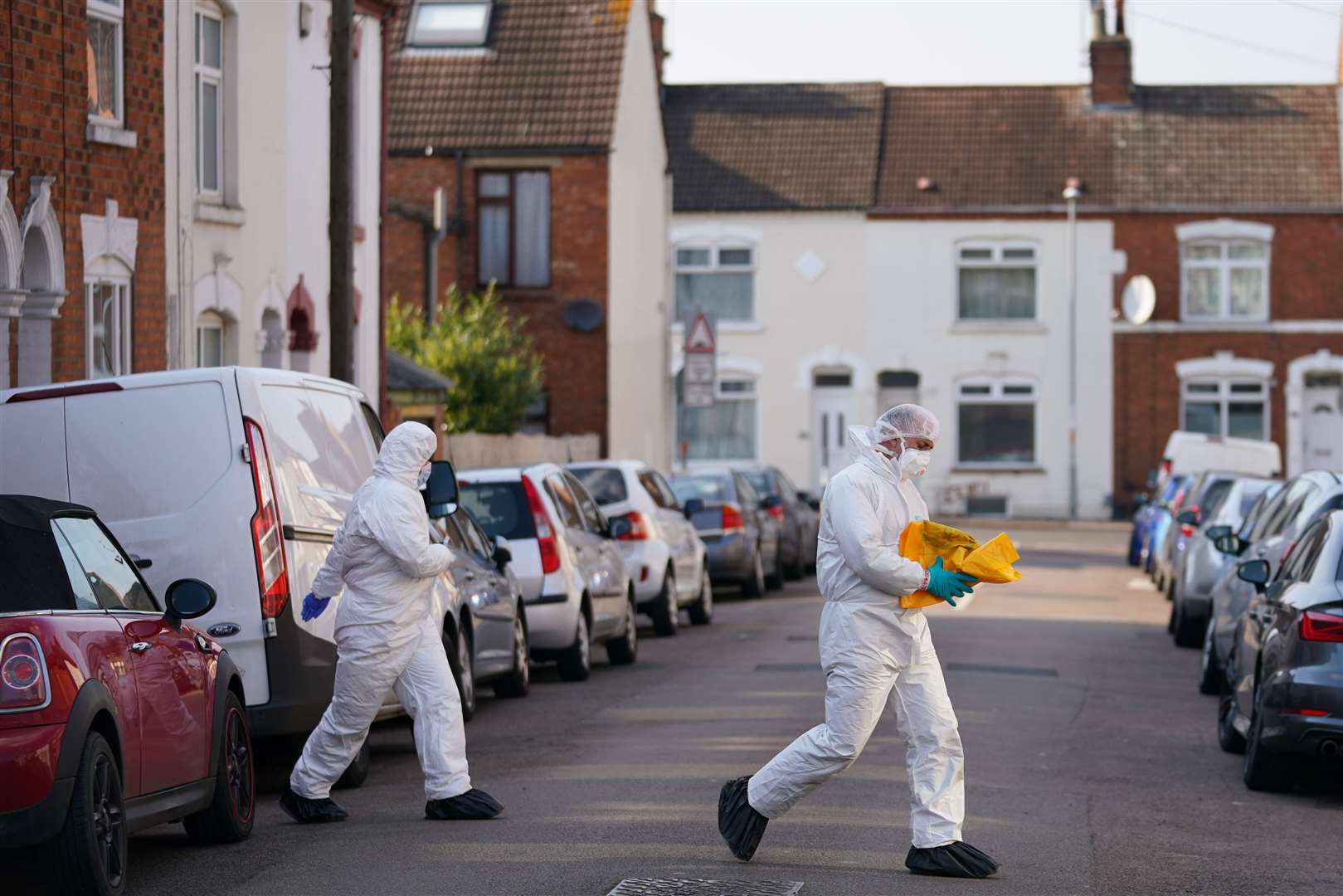 Forensic officers at the scene in Moore Street, Kingsley, Northampton following the discovery of human remains in a rear garden (Jacob King/PA)