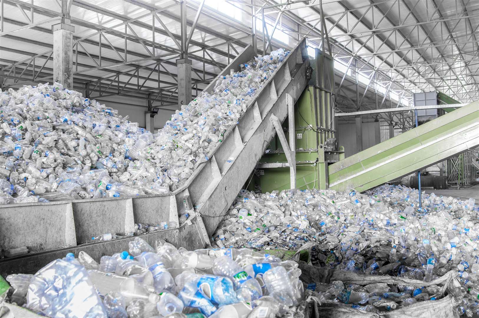 Single use plastic bottles piled up at recycling plant. Picture: Adobe