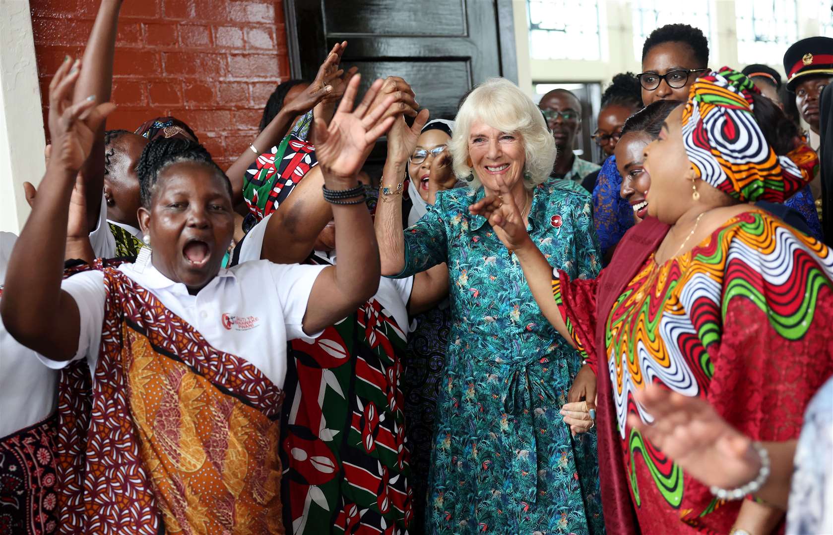 Camilla dances with volunteers and staff from Sauti Ya Wanawake (Chris Jackson/PA)