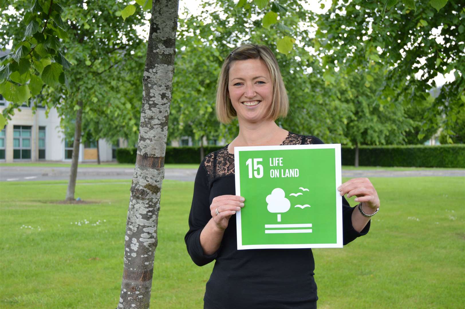 Deputy CEO of Keep Scotland Beautiful Catherine Gee, pictured here with the icon for UN Sustainable Development Goal 15 (Life on Land).
