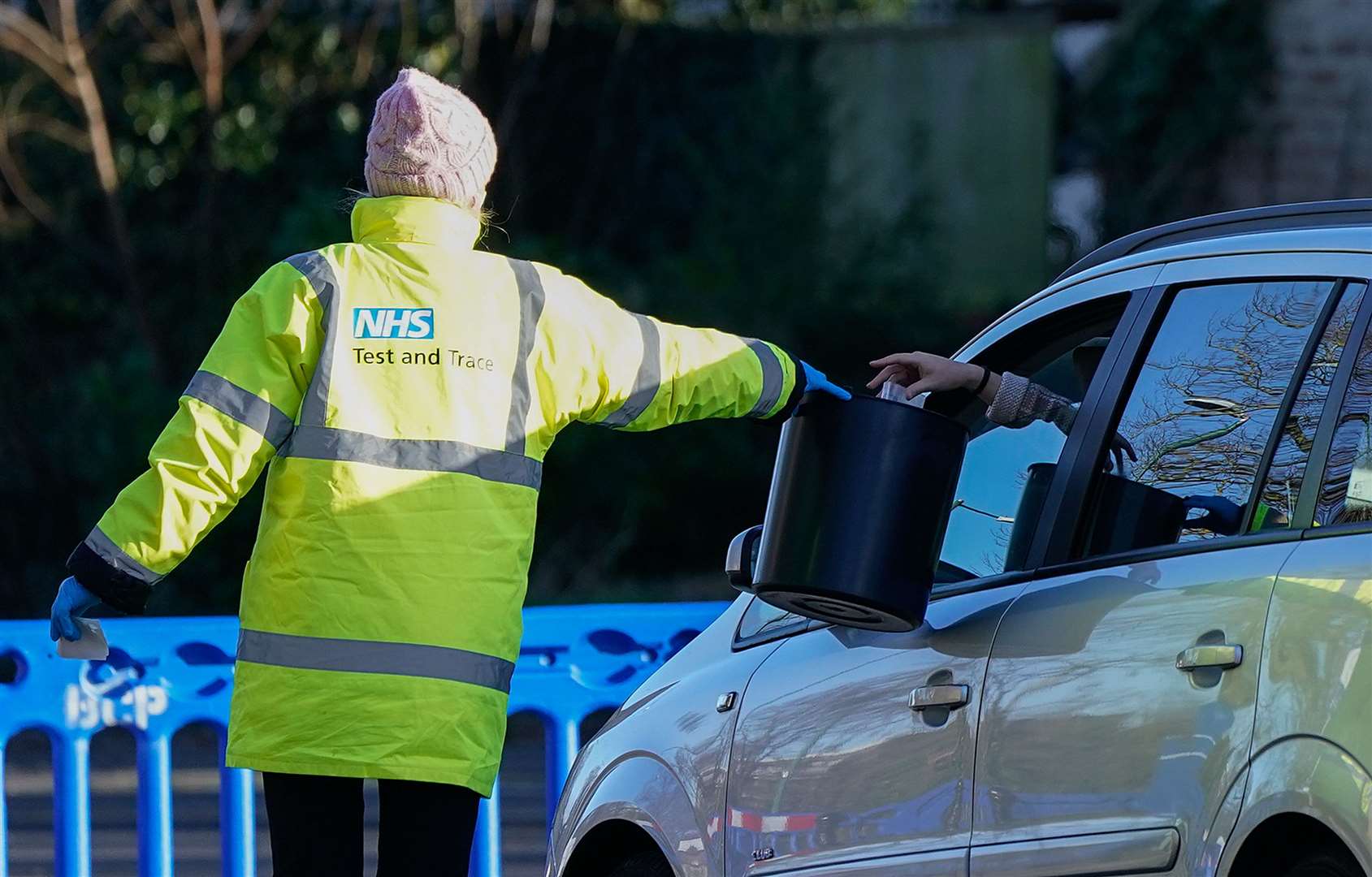 A member of NHS Test and Trace collects a sample from a member of the public at the drive-thru Covid-19 testing site on Hawkwood Road in Bournemouth (Andrew Matthews/PA)