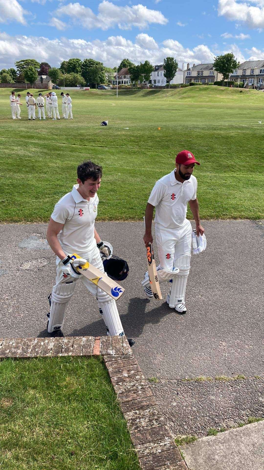 Magnus McGhee (17) walks off the field with captain Pal Dhami after a fine batting display.