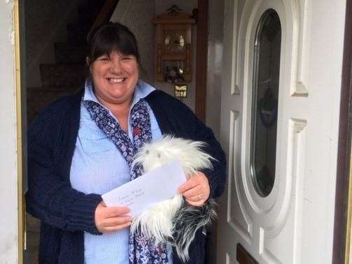 Irene McIvor is all smiles as her toy dog and vouchers are delivered.