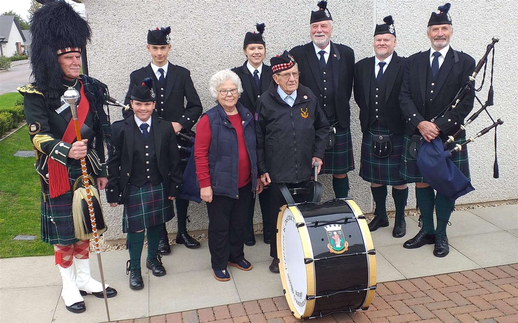 Donald and his wife Helen with Forres Pipe Band at their home in McRae Court.