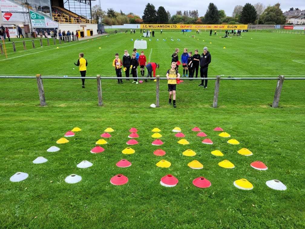 Under-12s coach Steven Hamilton and players playing cones Connect 4.