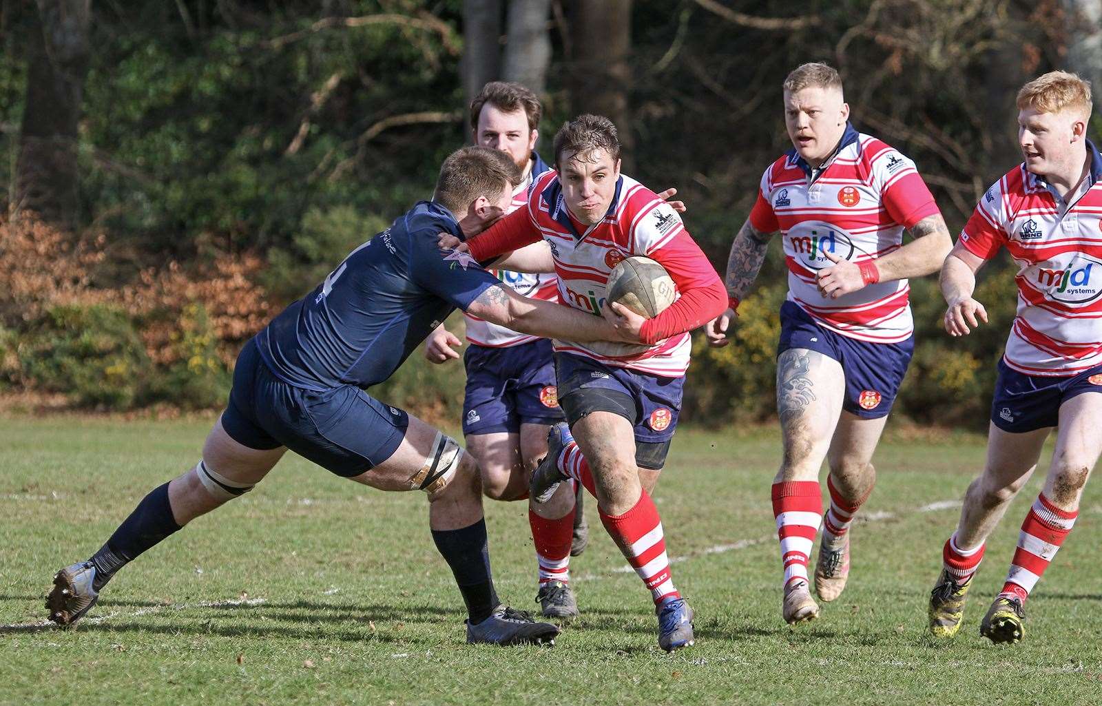 Cameron Hughes makes a break, handing off the Lossiemouth second row. In support are Mark Taylor, Lewis Scott and Ewan Simpson. Picture: John MacGregor