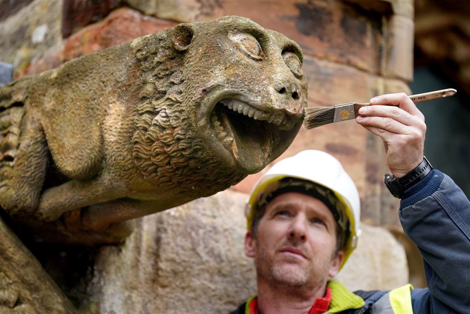 A gargoyle seemed happy to have his teeth brushed as part of conservation work at Rosslyn Chapel, Roslin, Midlothian, in May (Andrew Milligan/PA)
