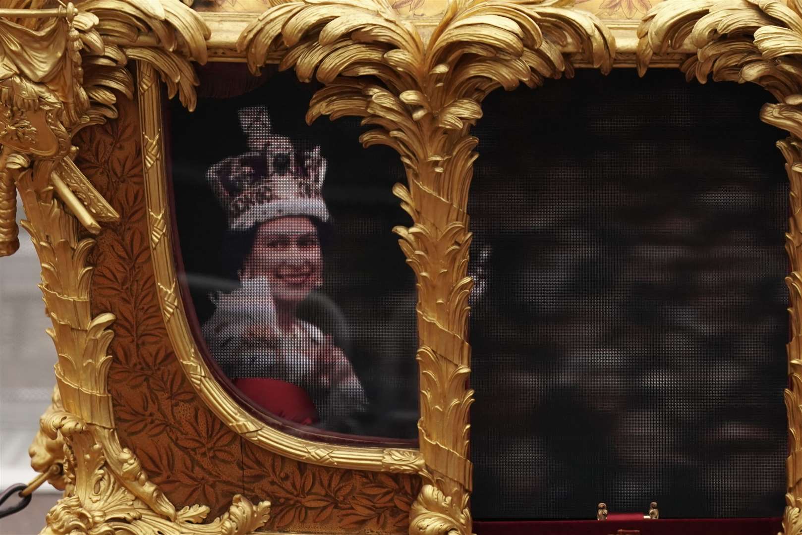 An image of the queen was projected onto the Gold State Coach (Aaron Chown/PA)