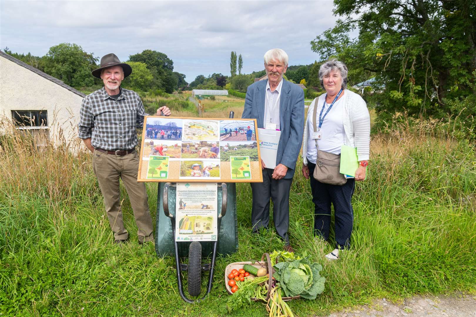 George Paul of Forres Friends of Woods and Fields with the judges Terry Stott and Penny Wright at the Chapelton Community Garden and Orchard.