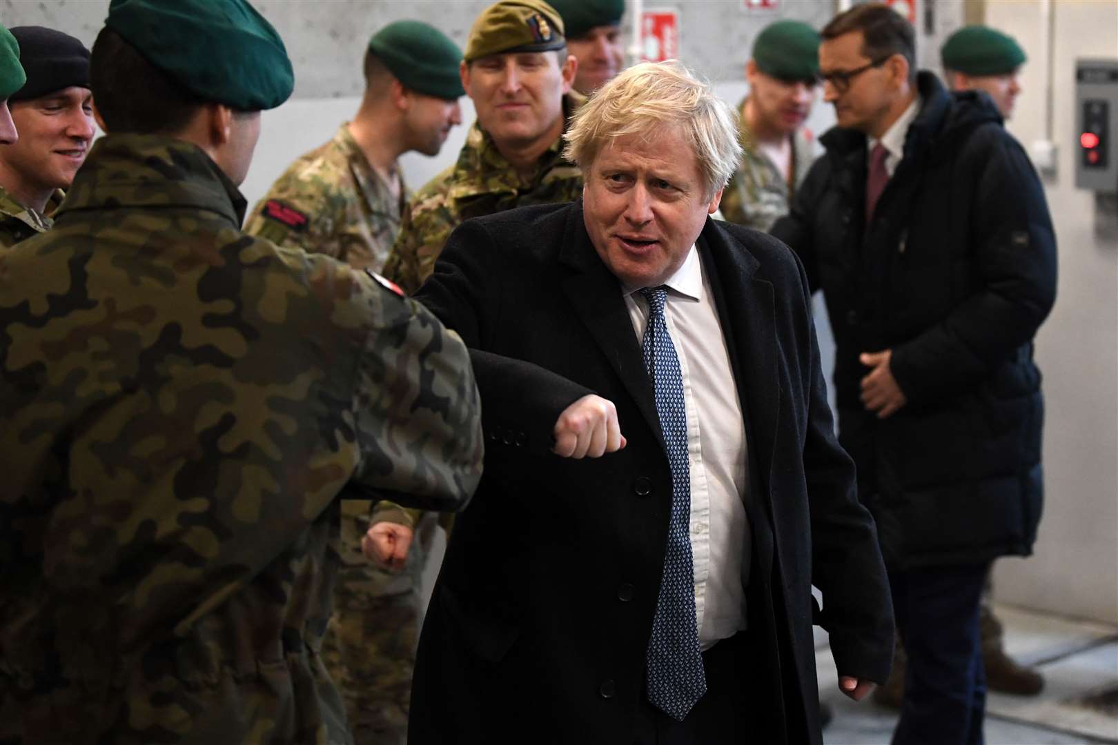 Prime Minister Boris Johnson greets troops during a visit Warsaw (Daniel Leal/PA)