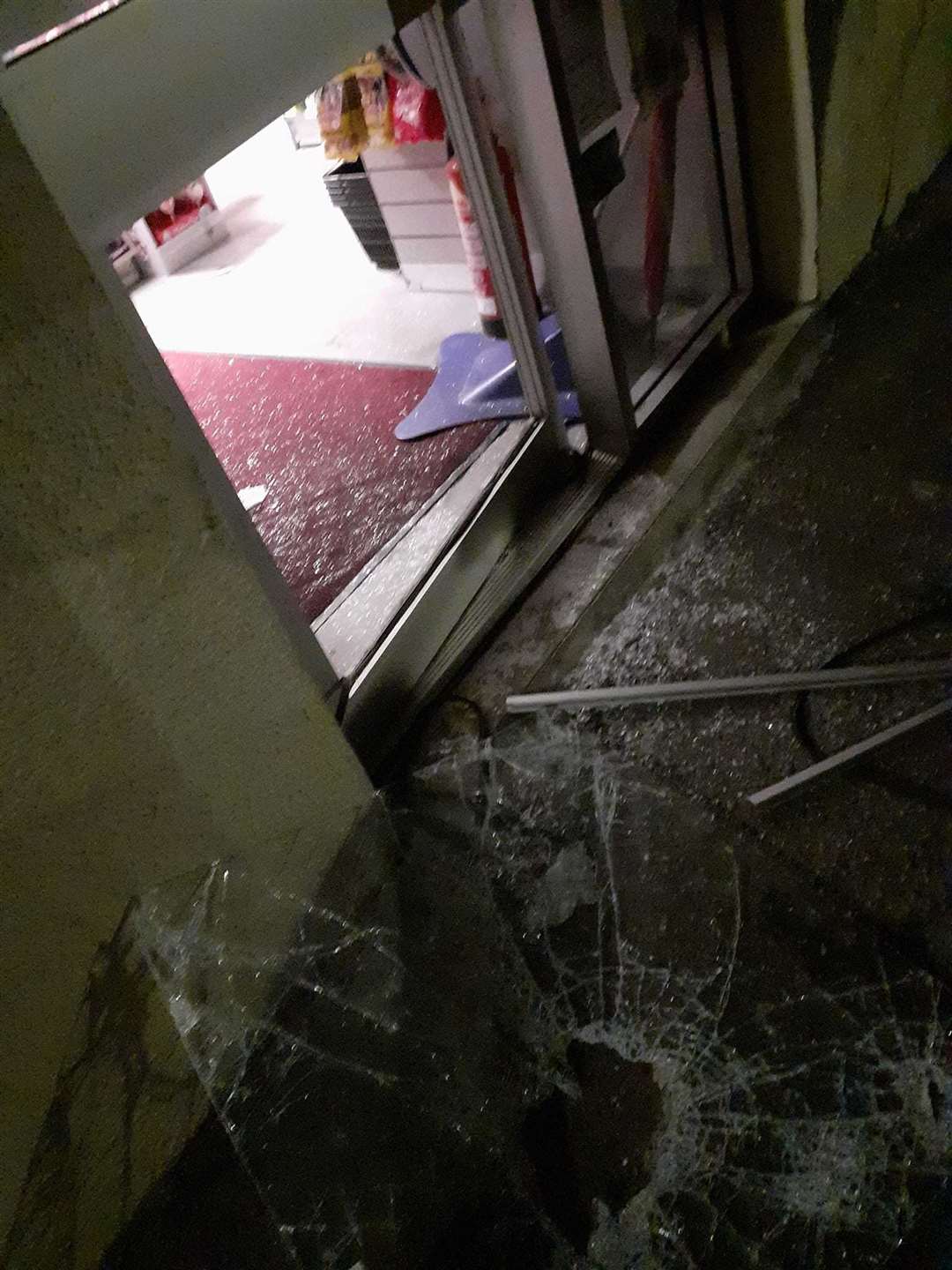 The smashed front door of the Burghead post office...Picture: Alexander Wilson