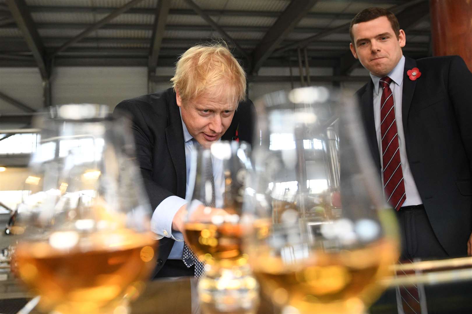 Prime Minister Boris Johnson tastes whisky at the Roseisle Distillery in Scotland near Moray with Douglas Ross MP (right), at the start of the General Election campaign.