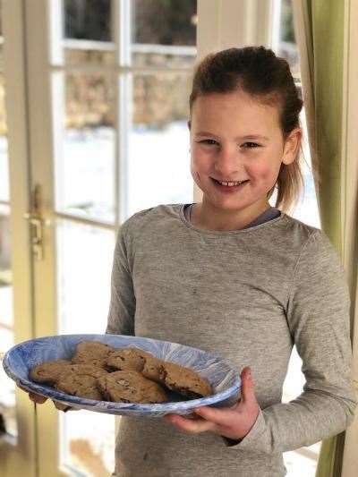 Juno Laing (8) making Charli's gooey choc chip cookies.