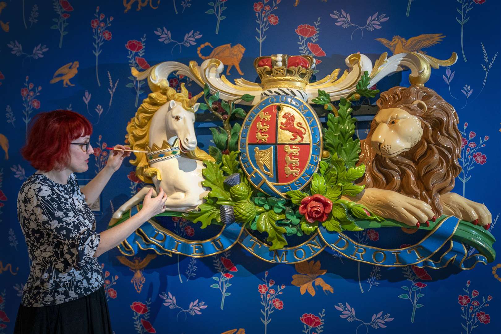 Conservation officer Anna Zwagerman cleans Queen Victoria’s Coat of Arms plaque (1848), which is on display at the museum (Jane Barlow/PA)