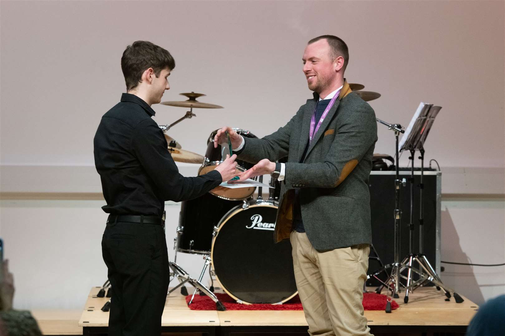Alexander Davidson presenting Edward Clark from Forres Academy with the winner's trophy at the Moray Young Musicians competition final at Elgin Academy. Picture: Beth Taylor