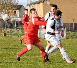 Forres Thistle's Scott Roy and Dave Christie of Islavale take their eyes off the ball during the Morrison Cup tie.
