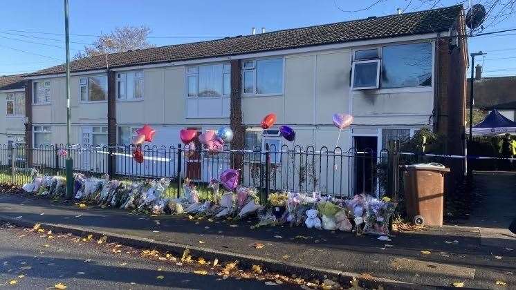 Balloons, flowers and other tributes left outside the flat in Clifton, Nottingham (Nottinghamshire Police/PA)