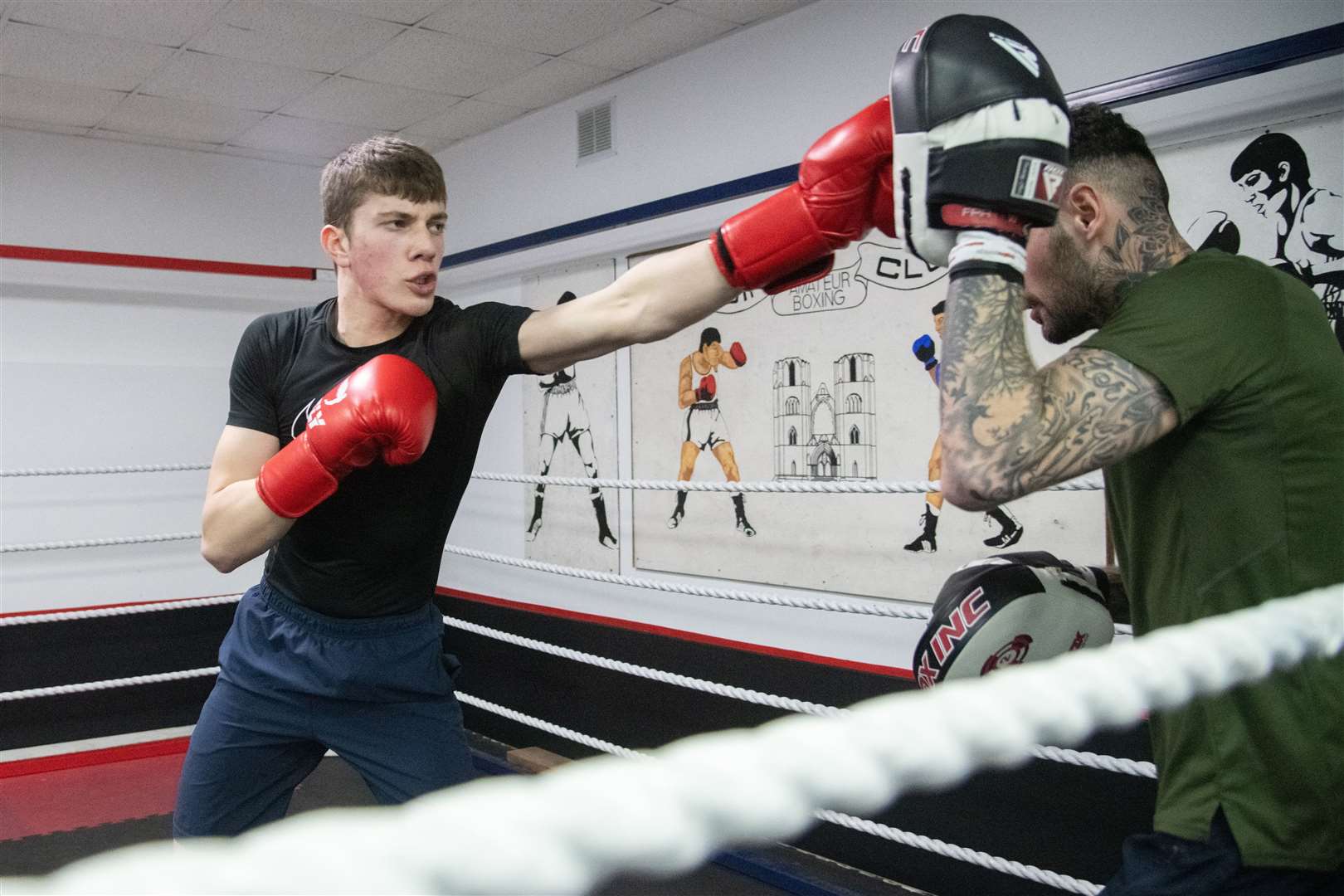 Marcus doing some padwork with a coach at Elgin Boxing Club. Picture: Daniel Forsyth