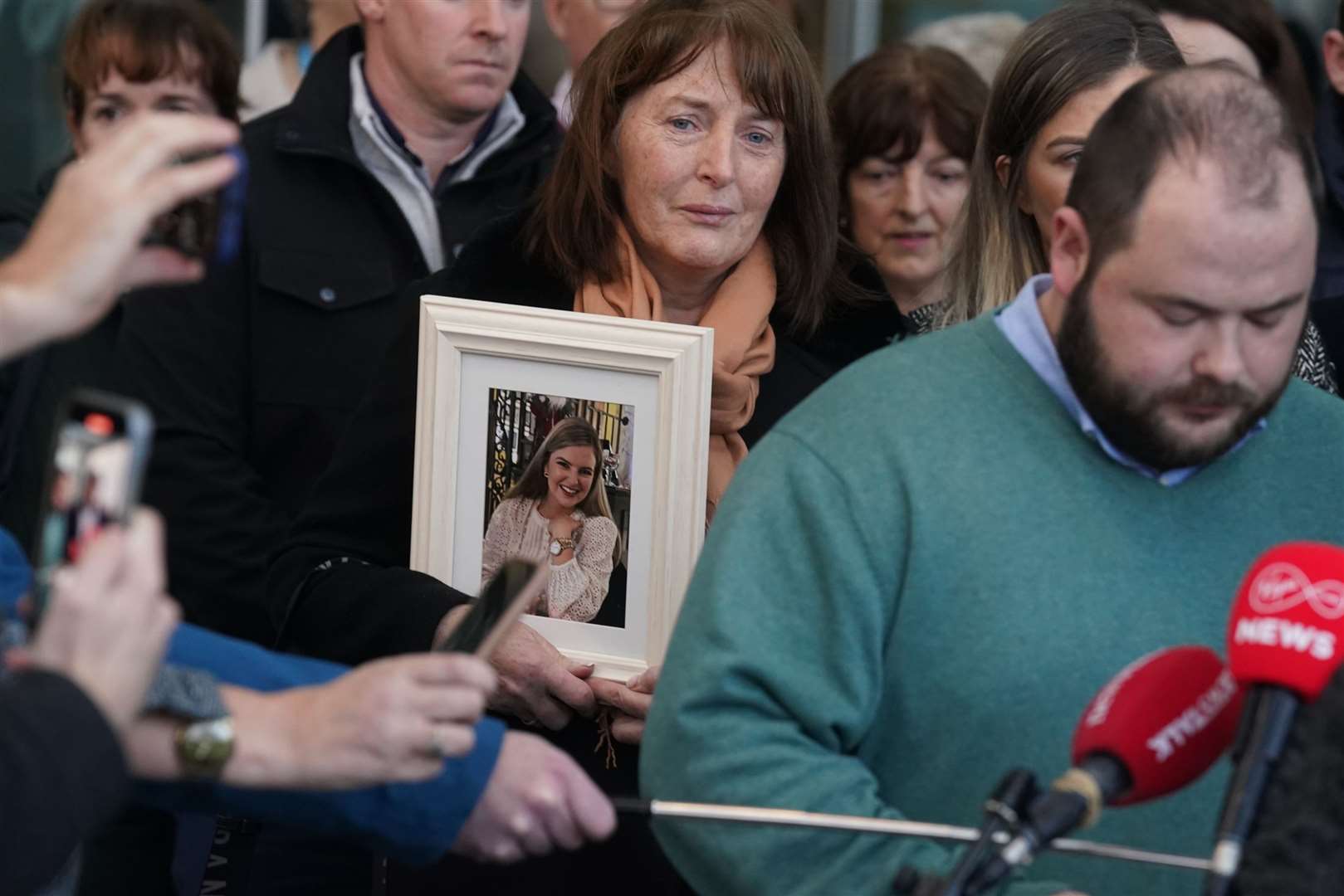 The mother of murdered teacher Ashling Murphy, centre, held a photograph of her daughter outside the Central Criminal Court in Dublin, after Jozef Puska, 33, was found guilty of the 23-year-old’s murder in Co Offaly in 2022 (Brian Lawless/PA)