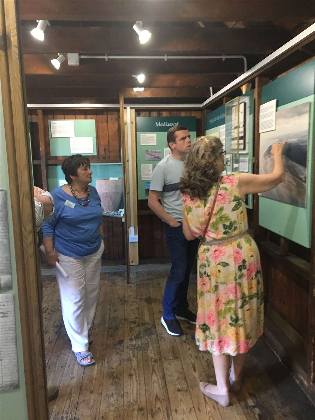 Douglas Ross MP being shown around the heritage centre by volunteers.