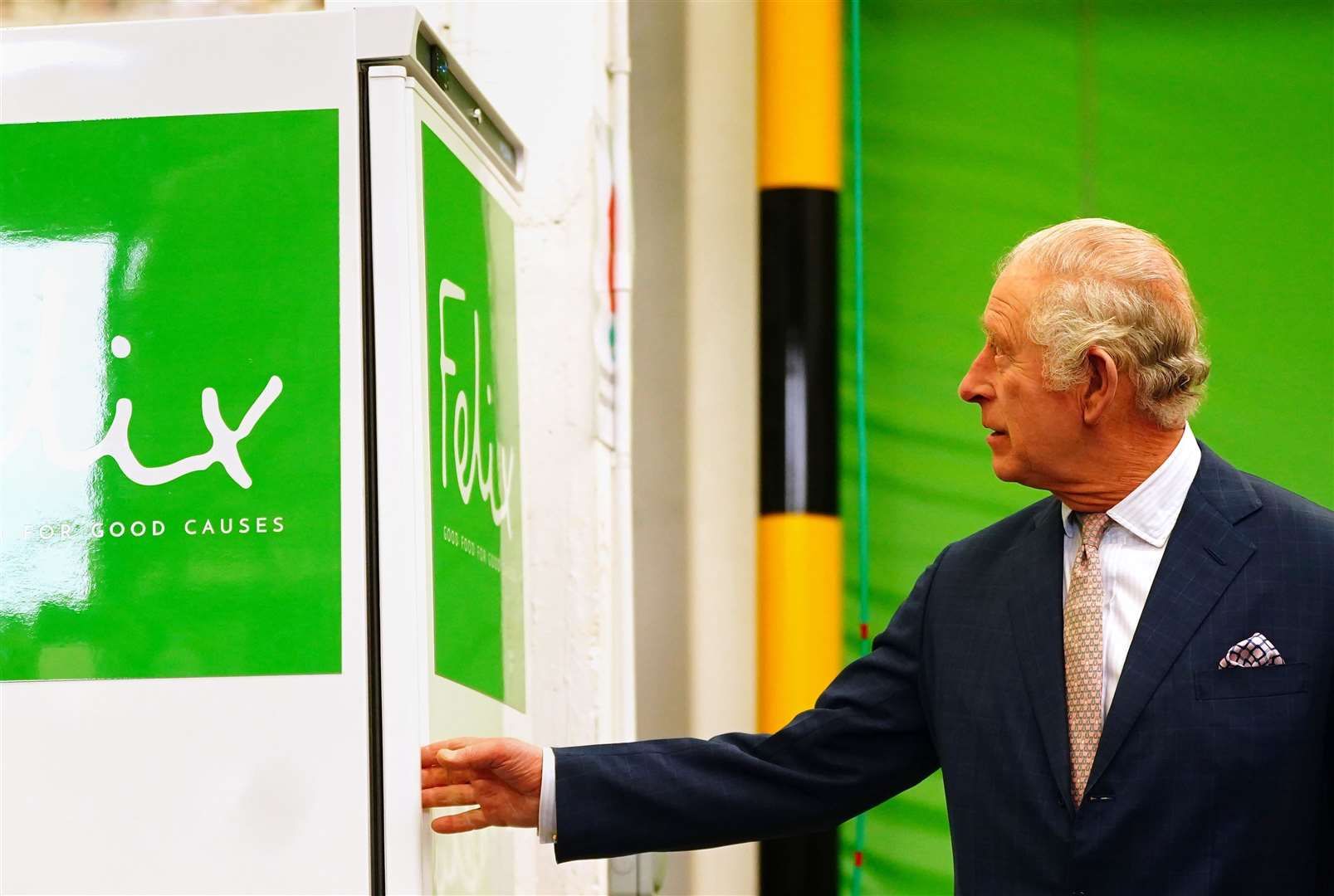 Charles looking at a freezer he unveiled during the engagement at The Felix Project (Victoria Jones/PA)