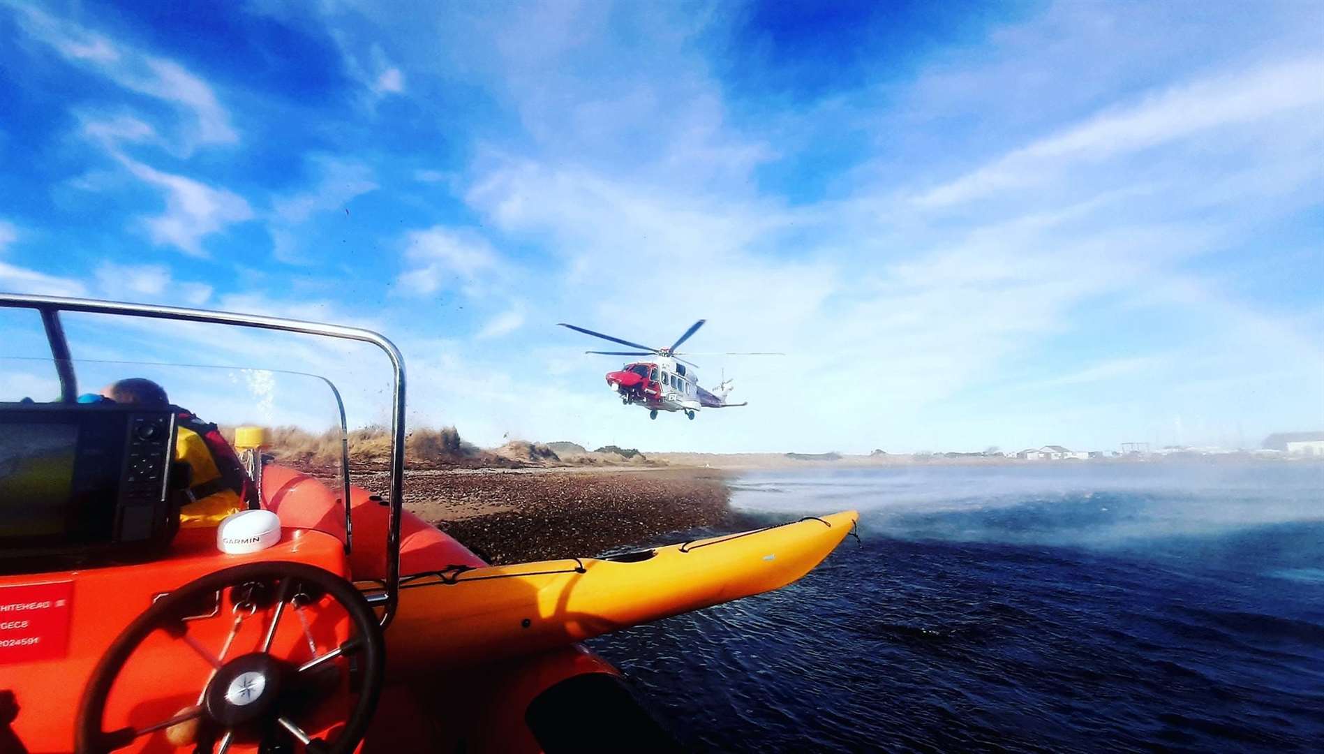 The MIRO team and Coastguard helicopter involved in the rescue of two kayakers off Findhorn yesterday afternoon.