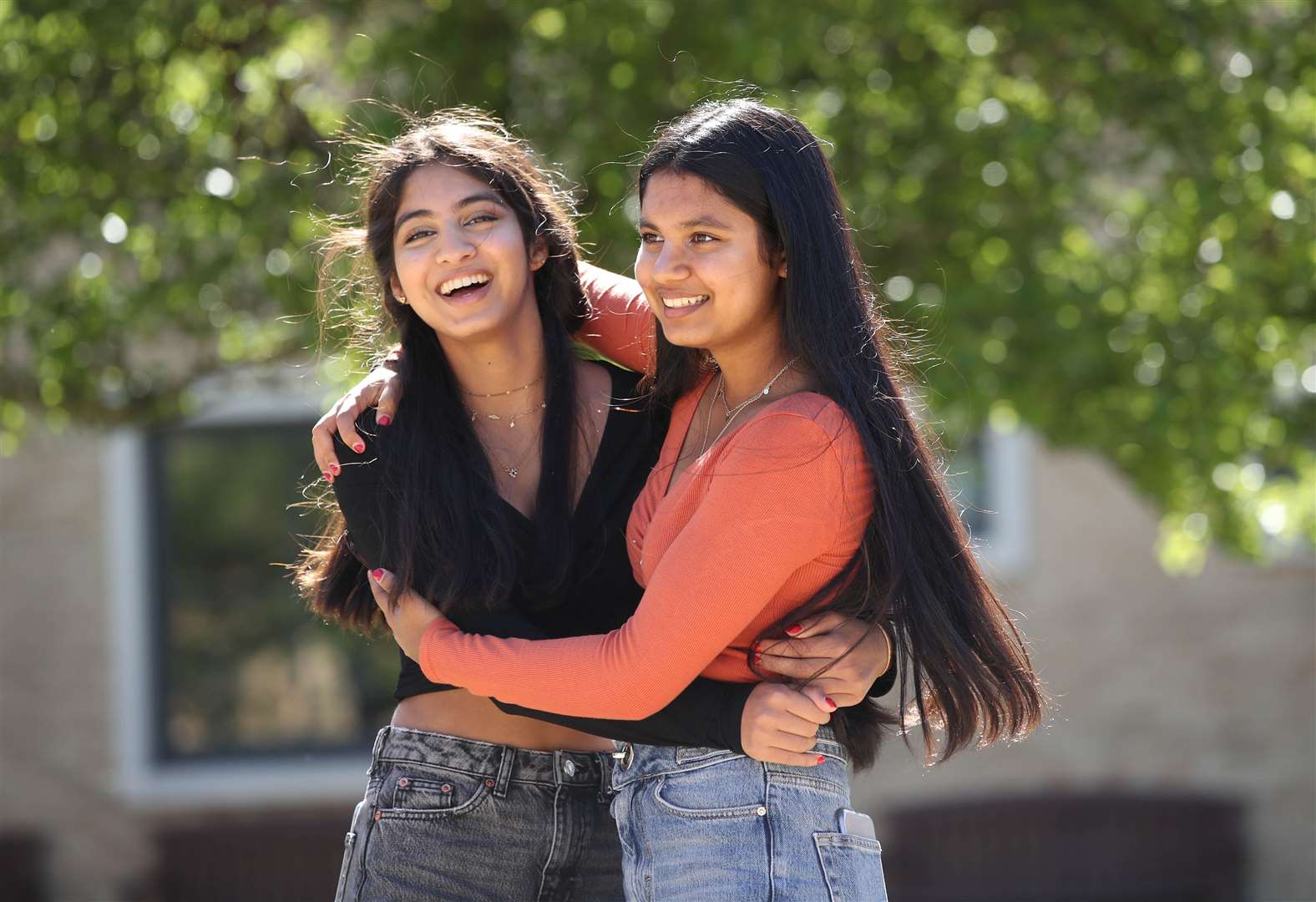 Twins Esha (left) and Risha Gupta celebrate (Danny Lawson/PA)