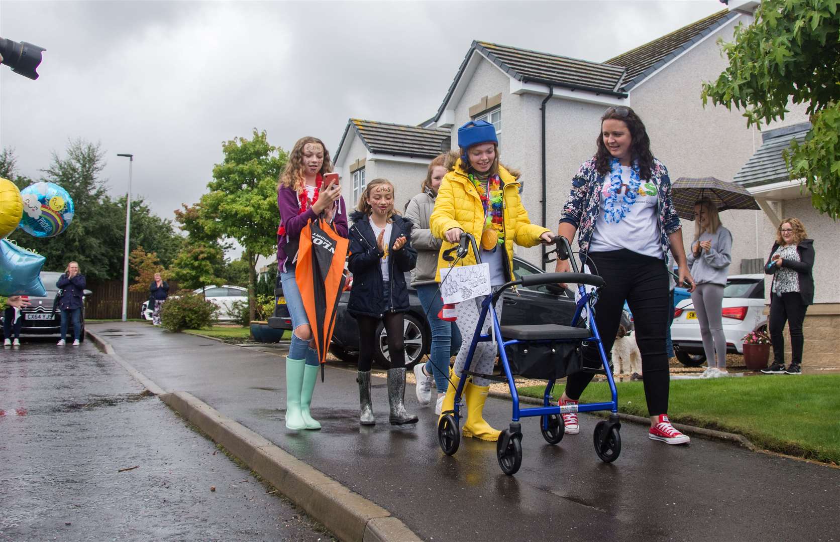 Ella Langdale completed the final two laps of her 100 lap walk around her block for CHAS, the charity who helps looks after her. Kristy Langdale (right) with sisters Evie (back left) and Erin (back middle) start the final laps...Picture: Becky Saunderson..