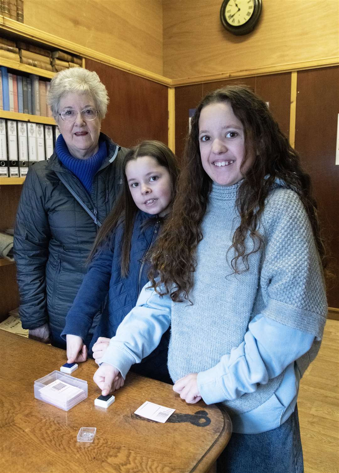 Volunteer Susie Haworth taking Laura and Lucy Hislop's fingerprints in the Tolbooth.