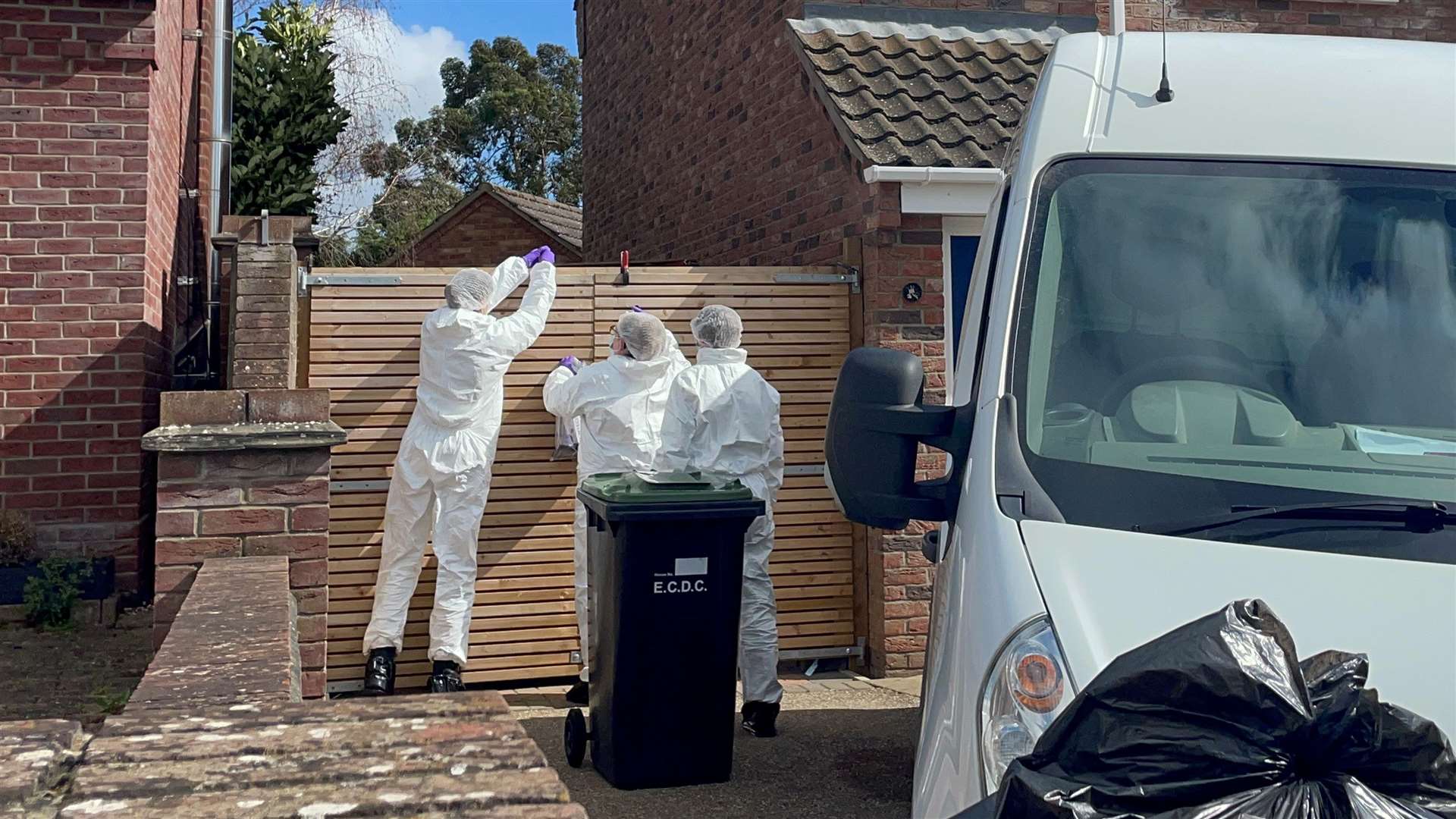 Forensics officers at the scene in The Row in Sutton, near Ely, Cambridgeshire, where police found the body of a 57-year-old man who had died from gunshot wounds (Joe Giddens/ PA)