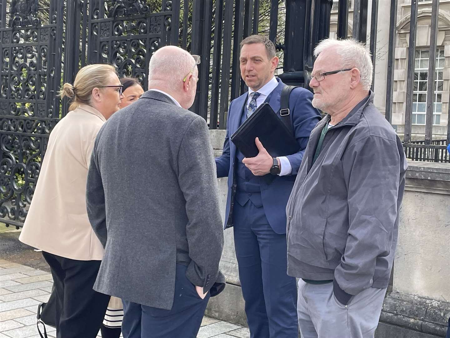 Solicitor Padraig O Muirigh (centre) with members of the families of Peter Ryan (known as Michael) and Tony Doris (Rebecca Black/PA)