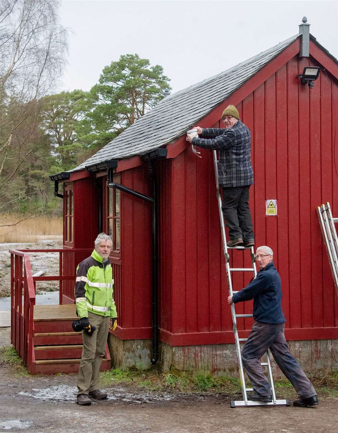 Trust treasurer Brian Higgs, trustee Mike Sutherland and Fire Protection Alliance CCTV controller Graham Morris installing CCTV at the boat house.