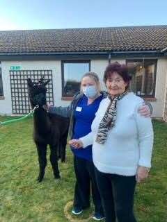 Angus, caregiver Holly Milne and resident Etta Alexander.