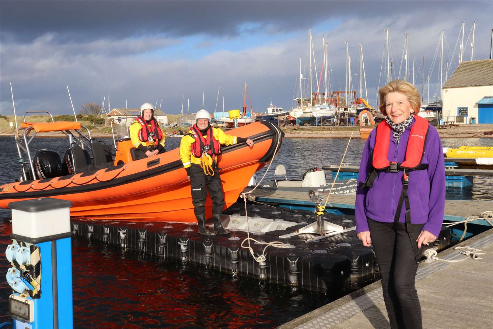MIRO crew Pippa Low on the boat and Alastair Macdonald on the dry dock with Margaret Stenton, trustee from The Gordon and Ena Baxter Foundation.