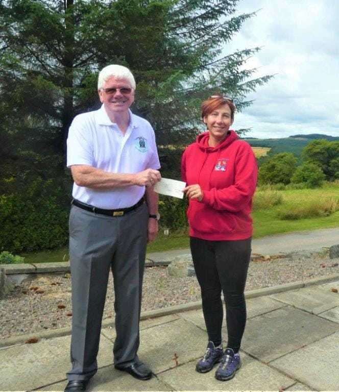 Ron Fowler, provincial grand master of the Freemasons of Moray and Nairn, hands over a cheque to Debbie Kelly, Moray School Bank development co-ordinator.