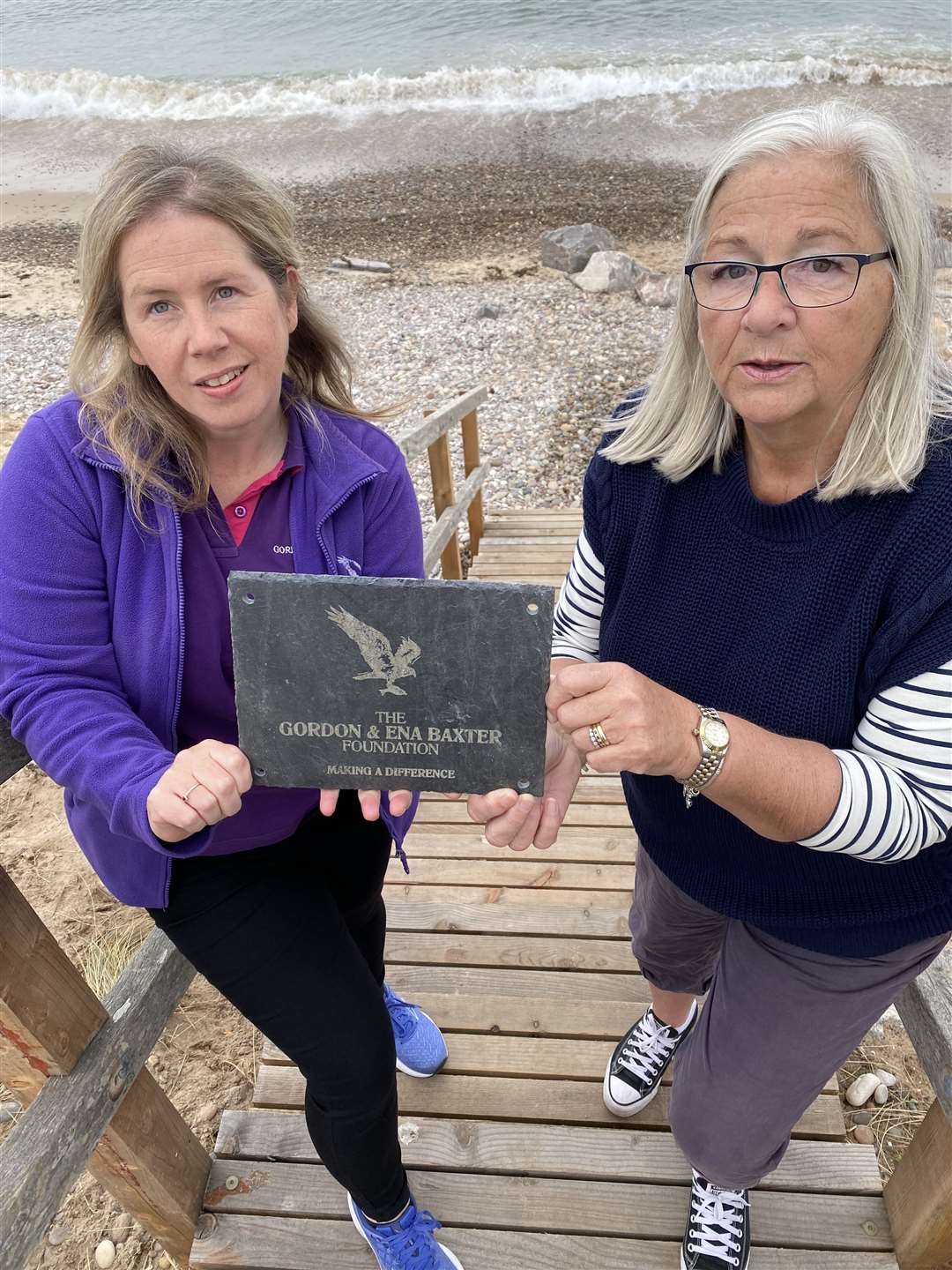 Cathy Low from Findhorn (right) with Sarah Rollo, and a plaque to mark the foundation’s donation.