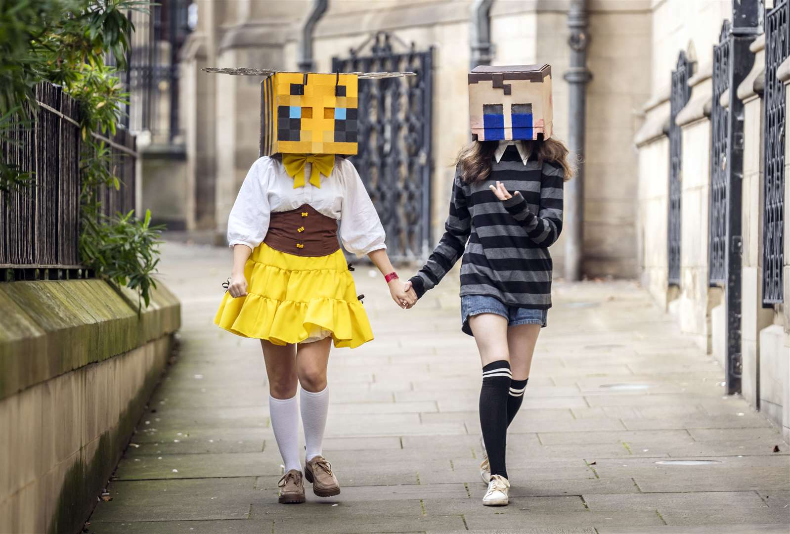 People in costume as a Minecraft bee (left) and Crying Child from Five Nights At Freddy’s 4 (right) (Danny Lawson/PA)
