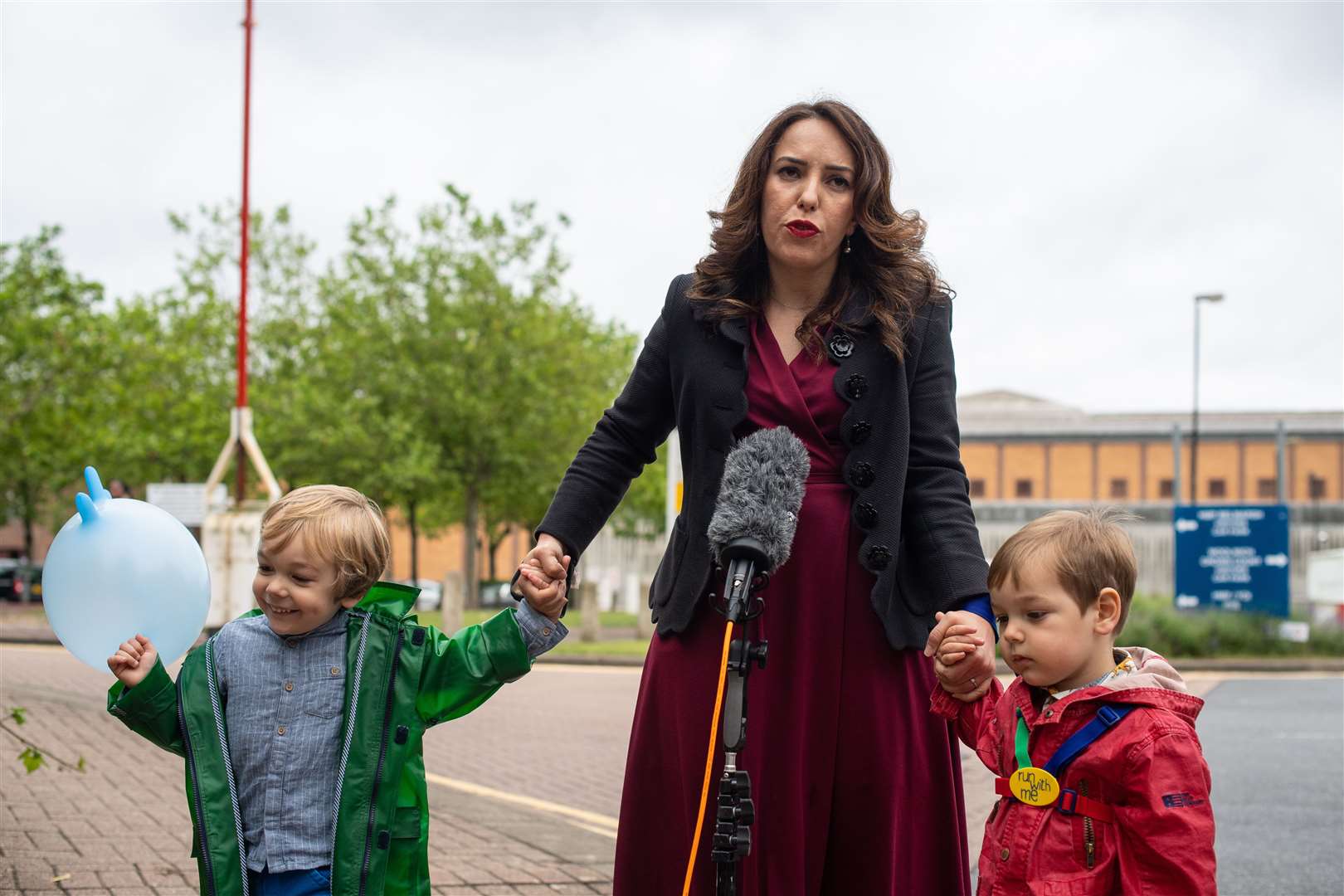 Stella Moris stands with her children, Gabriel and Max, as she speaks to the media outside Belmarsh Prison in 2021 (Dominic Lipinski/PA)