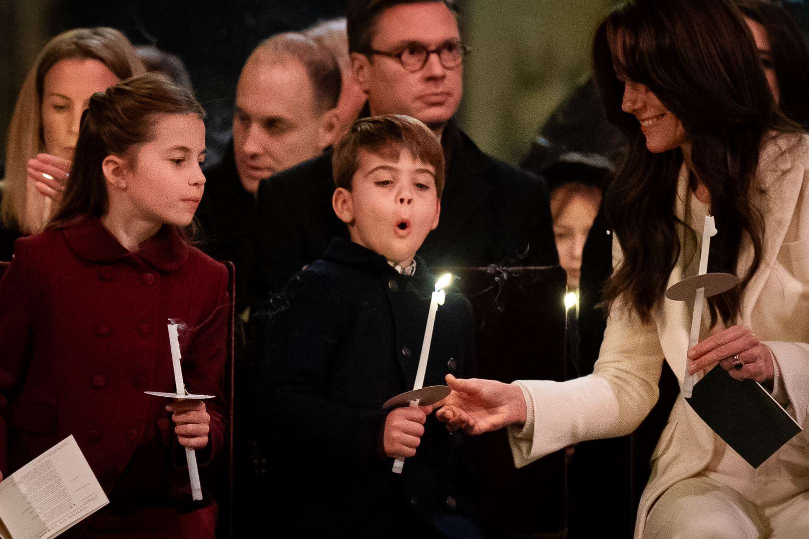(left to right) Princess Charlotte, Prince Louis blowing out his candle and the Princess of Wales during the Royal Carols – Together At Christmas service at Westminster Abbey in London (Aaron Chown/PA)