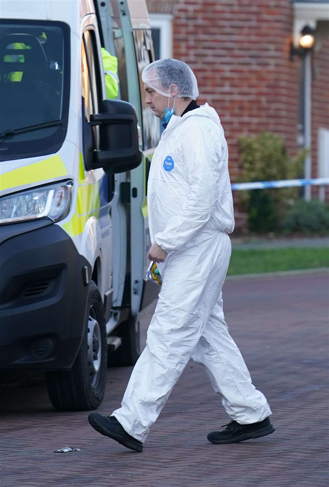 A forensic investigator outside a house in Costessey near Norwich (Joe Giddens/ PA)