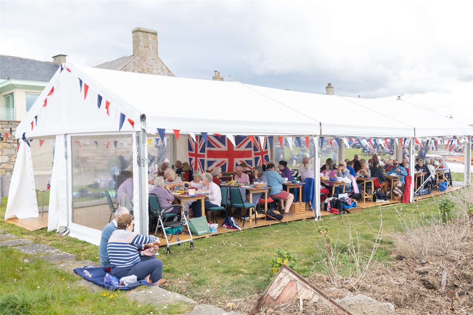 Family and friends gather inside the marquee to enjoy the Findhorn Village Coronation Weekend Celebrations at the Big Lunch. Picture: Beth Taylor