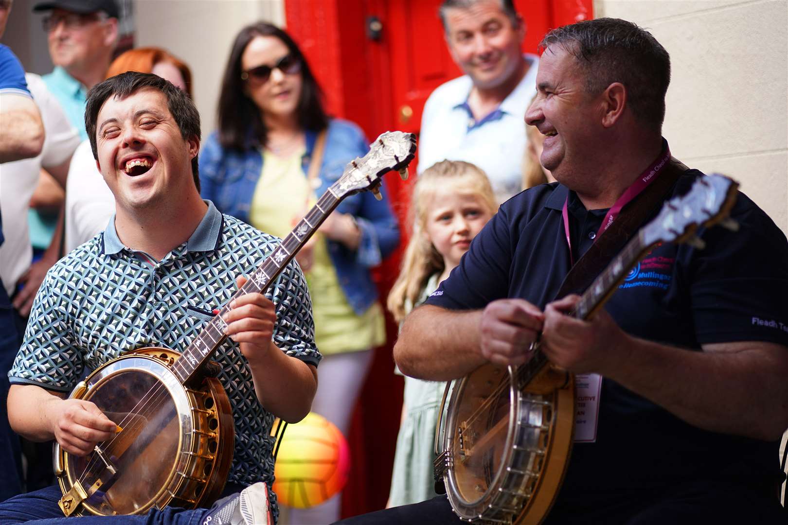 Banjo player Kevin Kennedy, left, performs on the streets of Mullingar as the Fleadh Cheoil na hEireann gets under way in Co Westmeath (Brian Lawless/PA)
