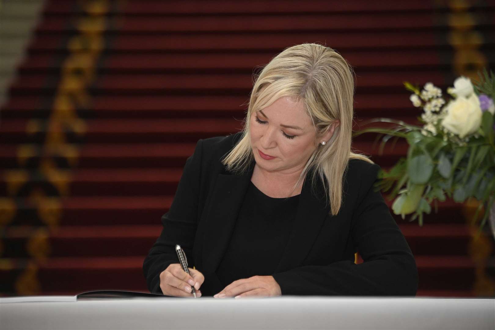 Sinn Fein leader Michelle O’Neill signs a book of condolence to the Queen at Belfast City Hall (Mark Marlow/PA)